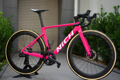 Nich Legend road bike frame, displayed on a work stand, showcasing its complete build readines and lightweight design.